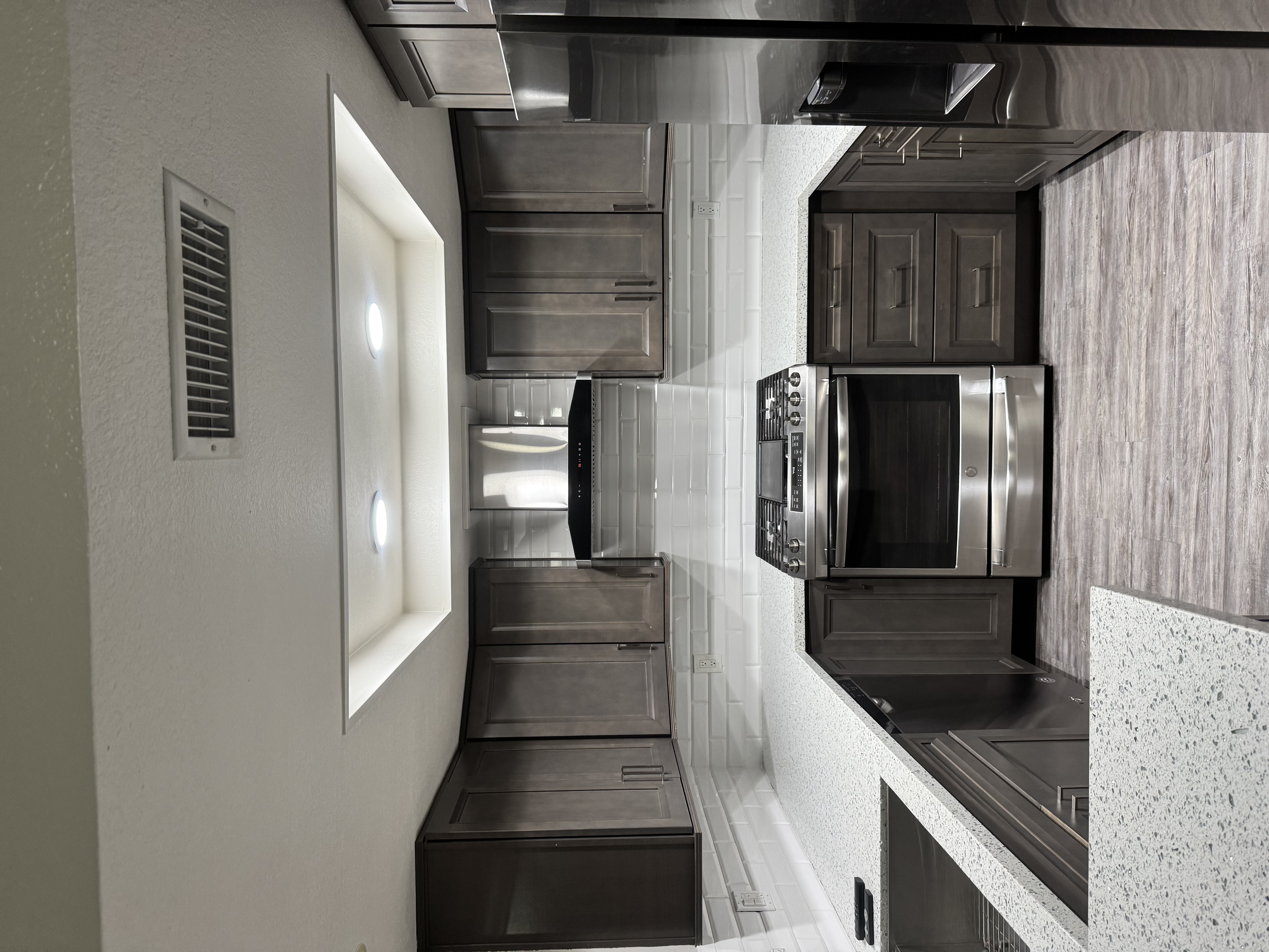Dark wood kitchen with stainless steel appliances