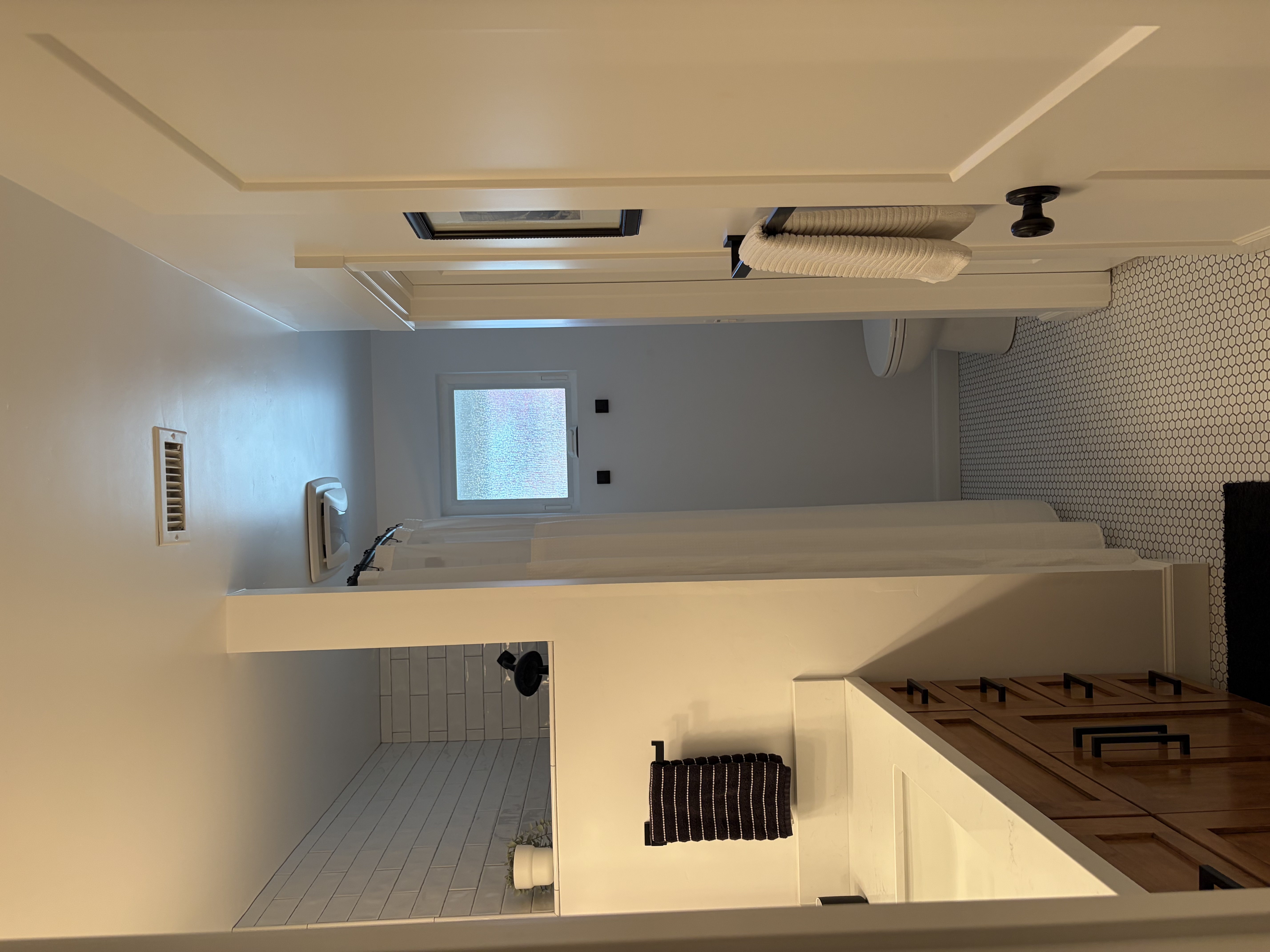 Bright bathroom with penny tile and clean counters