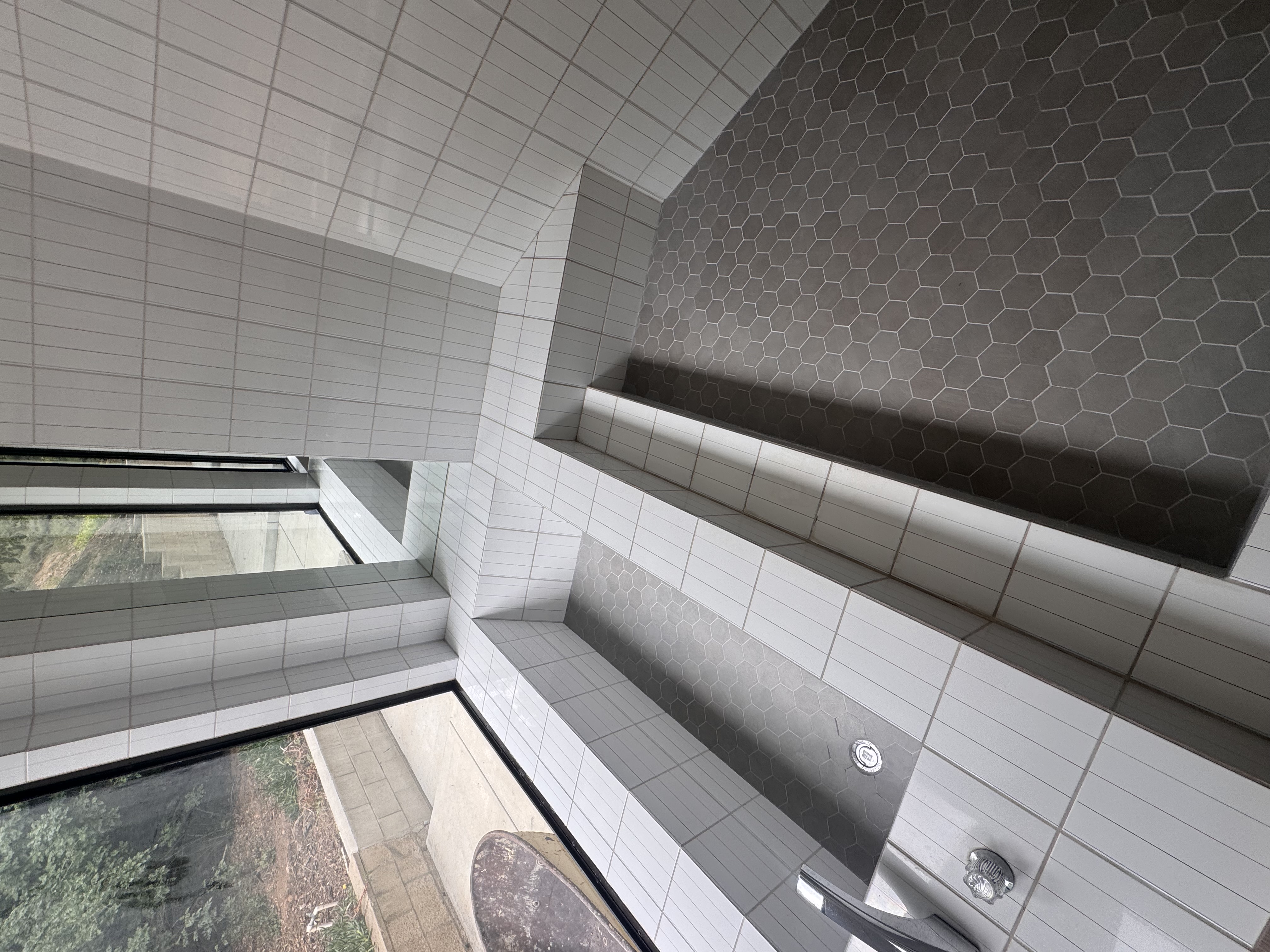 Hexagonal tile shower with built-in bench seat